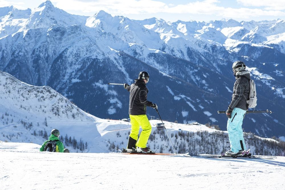 People on a high slope skiing
