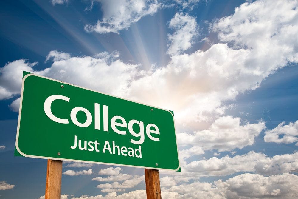 Road sign, street sign that says "college just ahead"