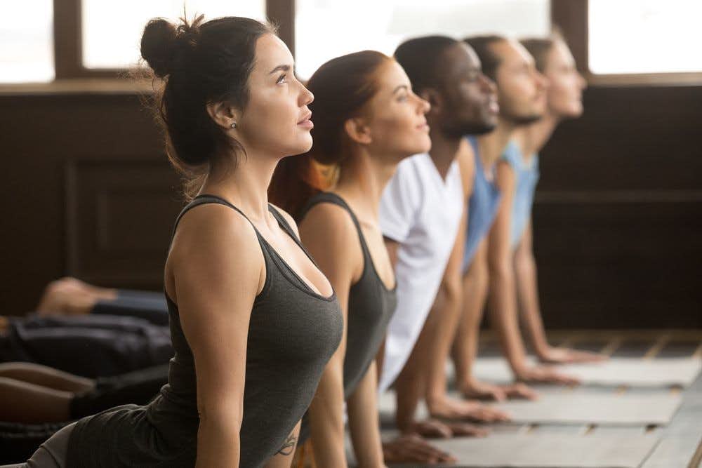A group of people stretching yoga class