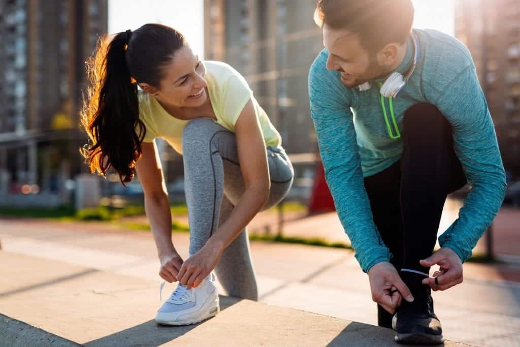 man and woman smiling while exercising
